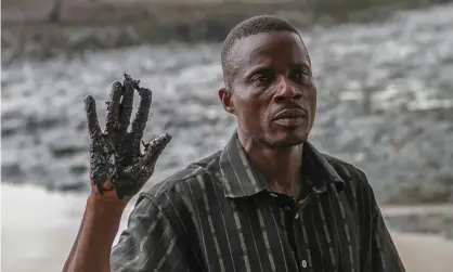  ?? Photograph: EPA ?? Eric Barizah, chief of Nigeria’s Goi community in Rivers State, shows oil pollution from leaks in the Niger delta.