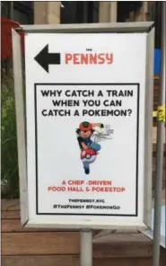  ?? ANICK JESDANUN — AP PHOTO/ ?? A sign at The Pennsy food court near New York’s Penn Station on Aug. 18 urges passersby to catch a Pokemon instead of a train.