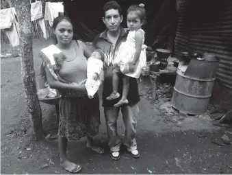  ??  ?? Miguel Ángel Tobar, known as the ‘Hollywood Kid,’ with his wife, Lorena, and their daughters, Las Pozas, El Salvador, 2014