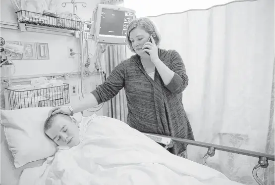  ?? Elizabeth Conley photos / Houston Chronicle ?? Jessica Large comforts her son, Brayden, as he tries to relax before surgery in Houston. She fought with doctors in Seattle for two years before she got him here.