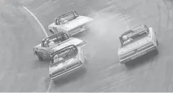  ?? AP fiLE ?? PEDAL TO THE METAL: In this May 14, 1962, photo, Ralph Earnhardt (75), far left, starts to spin out as he attempts to pass another car during the Rebel 300 auto race at the Darlington Raceway in Darlington, S.C.