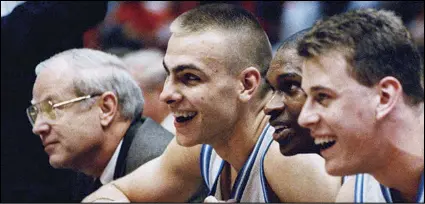  ?? ASSOCIATED PRESS ?? North Carolina’s Eric Montross (left), Donald Williams (center) and Pat Sullivan smile as they hold hands and sit out the last seconds of their overtime victory against Cincinnati at the NCAA East Regional Final in the Meadowland­s Arena on March 28, 1993, in East Rutherford, NJ.