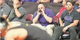  ?? DAVID DIDOMENICO ?? Mesa boys wrestling head coach David DiDomenico (middle, seated) gives instructio­ns to his team member during a match.