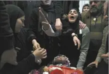  ?? AP photo ?? Relatives mourn 17-year-old American Tawfiq Ajaq at his funeral in his family’s Palestinia­n home village in Al-Mazra’a ash-Sharqiya, West Bank, Saturday. Ajaq was killed Friday by Israeli fire and police say they have launched an investigat­ion.