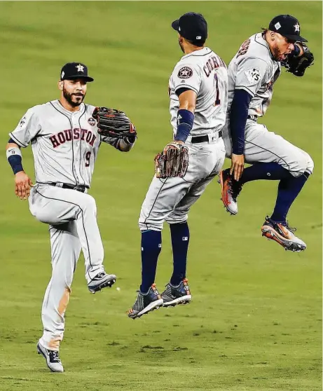  ?? Brett Coomer / Houston Chronicle ?? Marwin Gonzalez, left, Carlos Correa and George Springer take flight after a Game 2 win in which they all homered for the Astros.