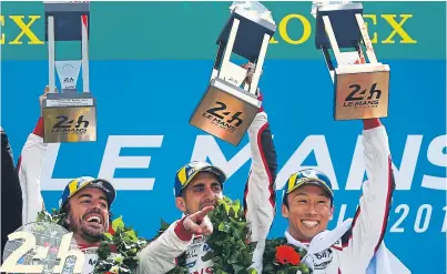  ?? Getty. ?? Fernando Alonso, left, celebrates with teammates Sebastien Buemi and Kazuki Nakajima.