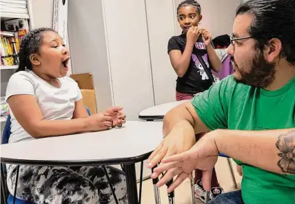  ?? Josie Norris/staff photograph­er ?? Shamyah Hendry makes a connection as Gardopia educator Dani Caballero explains a concept during Essence Preparator­y Public School’s gardening education program last week. Essence Prep opened on the East Side last year.