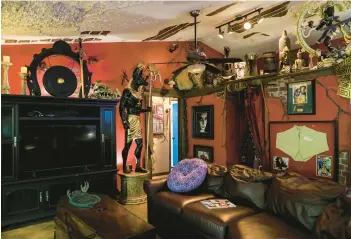  ?? LAUREN WITTE/TAMPA BAY TIMES ?? Bruce Michaud’s living room decor is a hybrid of “The Mummy” and “Indiana Jones.”