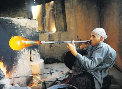  ?? Pictures: AFP ?? MAKING MAGIC. Afghan glass-blower Ghulam Sakhi crafts a glass object at his traditiona­l workshop in Herat province. Sakhi is one of the last makers of Herati glassware in the eponymous western city where the once-thriving industry has been shattered by decades of war, poverty, and cheap imports.