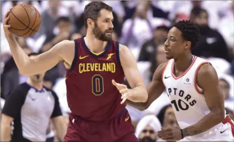  ?? FRANK GUNN — ASSOCIATED PRESS ?? Kevin Love posts up Raptors guard DeMar DeRozan during the first half of Game 2 of their NBA second-round series May 3 in Toronto.