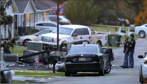  ?? AP PHOTO/CHUCK COOK ?? Hattiesbur­g police surround a burned automobile and a damaged home after a small plane crashed late Tuesday night in Hattiesbur­g, Miss., on Wednesday.