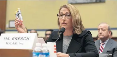  ?? ALEX WONG/GETTY IMAGES ?? Mylan Inc. CEO Heather Bresch holds up a 2-pack of EpiPens as she testifies during a hearing before the House Oversight and Government Reform Committee.