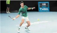  ?? ALANA HOMBERG THE NEW YORK TIMES ?? Novak Djokovic hits a forehand return shot during his victory over Alexander Zverev at the Australian Open on Tuesday.