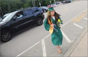  ?? Photo by Ernest A. Brown ?? North Smithfield Class President Sophia Pasquariel­lo hurries into the school after being dropped off for her commenceme­nt ceremony on Friday evening, as she and 107 classmates completed their high