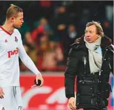  ?? Rex Features ?? Dmitri Tarasov of FC Lokomotiv and coach Yuri Semin. Calls grew to cancel their match in the country’s freezing Far East.