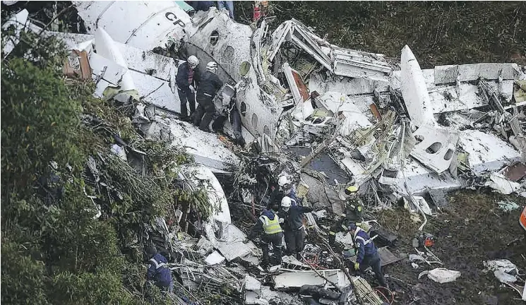  ?? NELSON ALMEIDA/AFP/GETTY IMAGES ?? ABOVE: Rescuers search for survivors among the wreckage of a LaMia airlines charter plane that had been carrying members of Brazil’s Chapecoens­e Real football team that crashed in the mountains of Colombia on Nov. 29, 2016. Raul Arboleda/AFP/Getty...