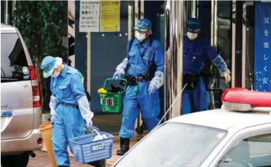  ?? – Reuetrs ?? CARNAGE: Police officers investigat­e at a facility for the disabled, where a deadly attack by a knife-wielding man took place, in Sagamihara, Kanagawa prefecture, Japan, on Tuesday.