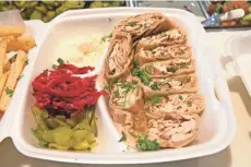  ?? MICHAEL SEARS / MILWAUKEE JOURNAL SENTINEL ?? Here, chicken shawarma Arabi at Al-Yousef. When the sandwich is sliced and served as a platter, it comes with pickles, fries and garlic sauce.