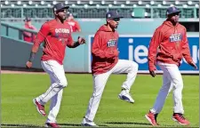  ?? CHARLES KRUPA/AP PHOTO ?? Eduardo Nunez, left, Mookie Betts, center, and ex-New London great Rajai Davis, right, stretch in the outfield prior to a work out at Fenway Park on Tuesday. The Red Sox begin postseason play on Thursday against the Astros in Houston.