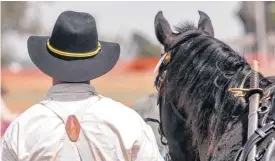  ??  ?? Competitor­s look on as members compete during the U.S. Cavalry Associatio­n national competitio­n.