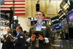  ?? SETH WENIG — THE ASSOCIATED PRESS ?? Traders work on the floor at the New York Stock Exchange in New York, Tuesday. Wall Street wobbling between gains and losses Tuesday in its first trading after tumbling into a bear market on worries about a fragile economy and rising rates.