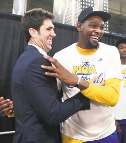  ?? Scott Strazzante / The Chronicle ?? First-year Warriors forward Kevin Durant celebrates with general manager Bob Myers in San Antonio.