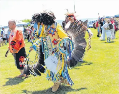  ?? ERIN POTTIE/CAPE BRETON POST ?? Dressed in colourful regalia, powwow dancers invited guests to join them in dancing circles around the field in Eskasoni on Saturday.