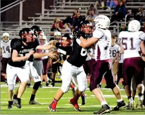  ?? TIMES photograph­s by Annette Beard ?? Phillip Brown, No. 62, Blackhawk freshman, blocked an Eagle defender to give the Blackhawk running back a clear lane down the field.