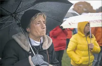  ??  ?? Carol Pitulski of Pleasant Hills watches a performanc­e Friday during the rally. About 400 people attended.