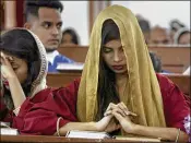  ?? FAREED KHAN / ASSOCIATED PRESS ?? A Pakistani Christian girl prays during midnight Christmas Mass at Christ Church in Karachi, Pakistan, on Monday. Police were deployed to guard historic cathedrals in Karachi and Lahore.