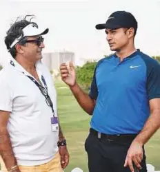  ?? Virendra Saklani/Gulf News ?? American golfer Julian Suri (right) with his father Jagan Suri, who is former tennis players, after finishing his first round of DP World Tour Championsh­ip yesterday.