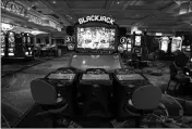  ?? ASSOCIATED PRESS ?? CHAIRS ARE REMOVED to keep social distancing between players as a coronaviru­s safety precaution at an electronic gaming machine in the closed Bellagio hotel and casino, Wednesday in Las Vegas. Casino operators in Las Vegas are awaiting word when they will be able to reopen after a shutdown during the coronaviru­s outbreak.