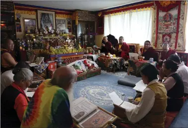  ?? JESSIE WARDARSKI — THE ASSOCIATED PRESS ?? Jalue Dorje and his fellow monks pray during a ceremony paying homage to Guru Rinpoche, the Indian Buddhist master who brought Tantric Buddhism to Tibet, at Dorje’s home July 19in Columbia Heights, Minn. Over two days the group prayed for victims of natural disasters, war and COVID-19, and for the peace and happiness of beings worldwide.