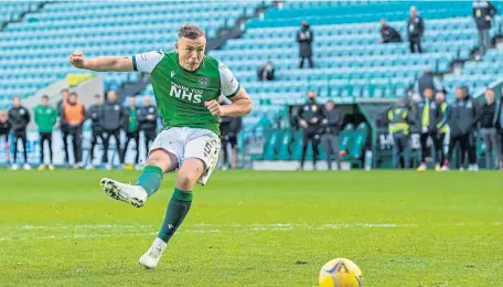  ??  ?? Hibs’ Ryan Porteous slots home the winning penalty