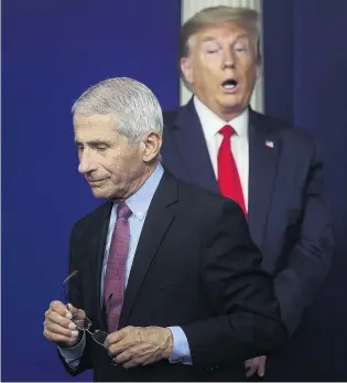  ?? PHOTO: REUTERS ?? At odds . . . US President Donald Trump reacts as Dr Anthony Fauci steps away from the podium after speaking and answering questions at the daily Coronaviru­s Task Force briefing at the White House in Washington yesterday.