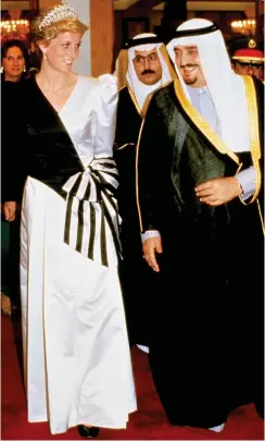  ??  ?? Modest: Diana in satin dress with King Fahd in 1986, and right, the original sketch for the gown