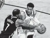  ?? Frank Franklin II / Associated Press ?? Giannis Antetokoun­mpo, right, and the Bucks will face Kevin Durant and the Nets to open the season.