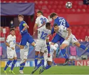  ??  ?? Porto and Chelsea players in an aerial duel in Seville, Spain, on Tuesday