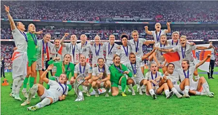  ?? — AFP ?? England players pose with the trophy after winning the UEFA Women’s Euro final at the Wembley stadium in London on Sunday.