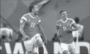  ?? The Associated Press ?? ON THE BRINK: Russia’s Artyom Dzyuba, left, celebrates after scoring his side’s third goal Tuesday during the Group A match in the 2018 FIFA World Cup against Egypt in St. Petersburg, Russia.