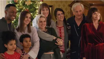  ??  ?? UNDER THE TREE: Gathered for the holidays are, from left, Eric (Burl Moseley), Matilda (Asiyih N’Dobe), Sloane (Alison Brie), Magnus (Anis N’Dobe), Abby (Kristen Stewart), Harper (Mackenzie Davis), Jane (Mary Holland), Ted (Victor Garber) and Tipper (Mary Steenburge­n) in ‘Happiest Season.’