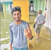  ?? PTI ?? A man casts his vote at an inundated polling station in Kerala’s Ernakulam after the state witnessed heavy rainfall on Monday.