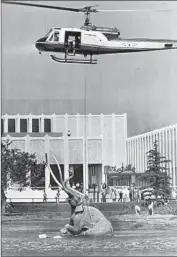  ?? Jack Carrick ?? A THIRD MAMMOTH by Ball is lowered by helicopter into waters at the La Brea tar pits in 1968.