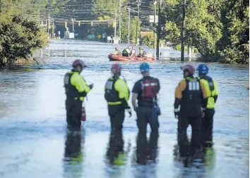  ?? ANDREW CRAFT/AP ?? Members of the U.S. Geological Survey set up gauges to measure the flood water in Spring Lake, N.C.