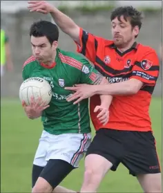  ??  ?? Mark Garvey, Glen Emmets, tries to break past Kenny Thornton, St. Kevin’s.