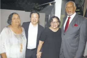  ??  ?? Dr Gloria Moodie (second right) and husband Dr Peter Wong (second left) shared a moment with Cabinet Secretary Douglas Saunders and his attorney-at-law wife Angela Robertson.