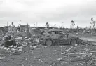  ?? RICHARD BURKHART/SAVANNAH MORNING NEWS VIA AP ?? Battered vehicles and debris show the destructio­n caused by a tornado in Ellabell, Ga., on April 5.