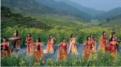  ?? ?? Twelve Girls Band, an all female Chinese musical group that features a mix of traditiona­l Chinese music with modern pop, jazz and rock, performs among canola terraces in Huangling Village, Wuyuan County, Jiangxi Province, March 11, 2019