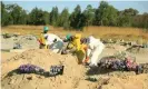  ?? Photograph: Aaron Ufumeli/EPA ?? Gravedigge­rs fill in a grave after the burial of another Covid-19 victim at the Zororo cemetery in Chitungwiz­a, near Harare.