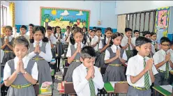  ?? HT ?? Students offer prayer inside the classroom of a city school as a preventive measure against swine flu.